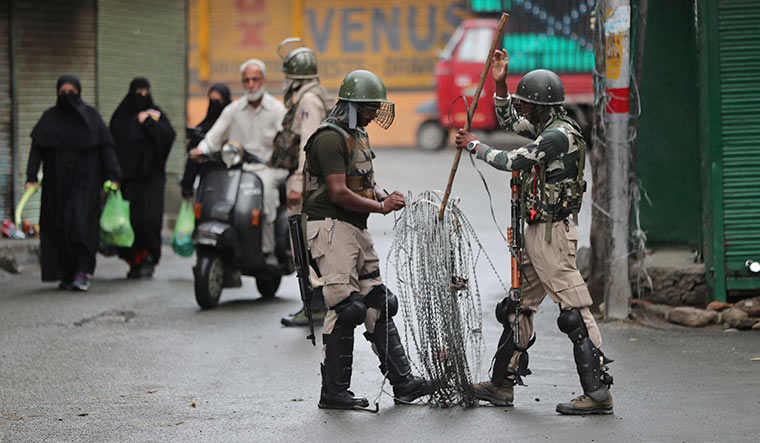 Valley of fear: Soldiers close off a street in Srinagar. Despite stringent security measures, protests are spreading in Jammu and Kashmir | AP