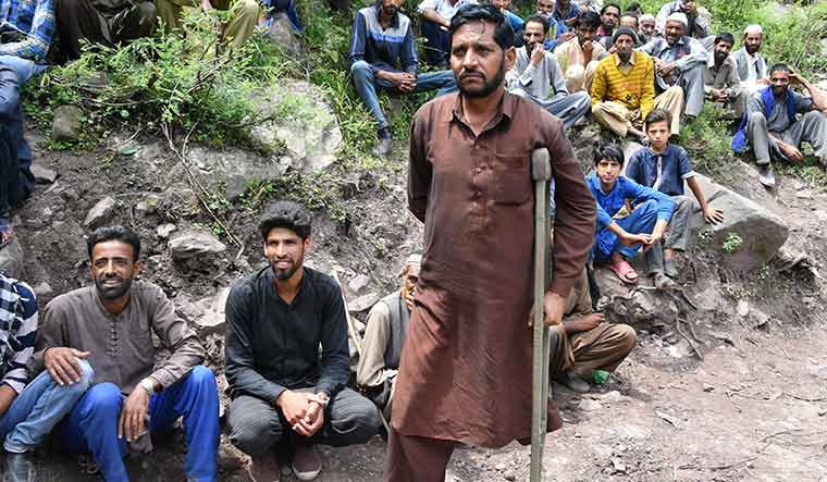 Looking ahead: Mohammad Sadiq with other villagers at Gohallan, a village along the LoC | Arvind Jain