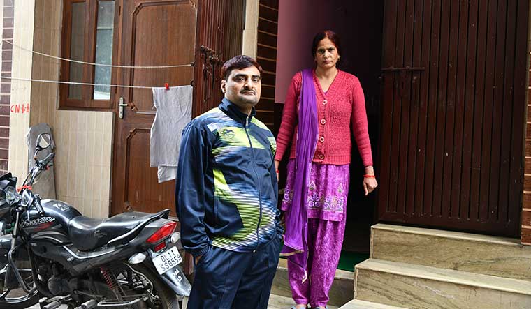 Poll windfall: Pinki Sharma from Rohini, the first person to receive ownership papers for her property in an unauthorised colony, with her husband, Parveen | Sanjay Ahlawat