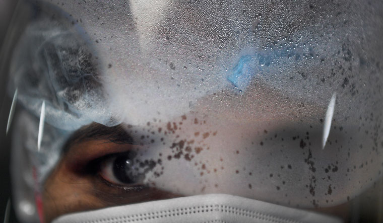 Under her watchful eye: Head nurse Carunia Bernard with a fogged-up face shield. In the Covid-19 ward, nurses rely on their eyes and voice to comfort and motivate critically ill patients