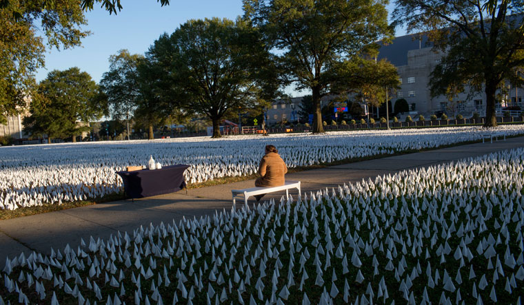 In memory: The last of the day’s light falls on flags planted at the Armory in Washington, DC, to remember some of the over two lakh Americans who died of Covid-19 | Getty Images