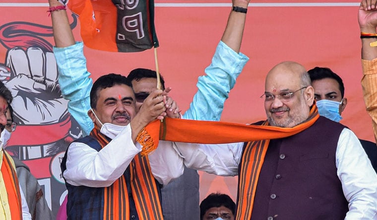 Grand welcome: Amit Shah with Suvendu Adhikari at a rally in West Midnapore | PTI