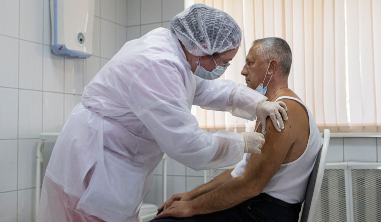 Injecting hope: A Russian medical worker administering a shot of Sputnik V in September | AP