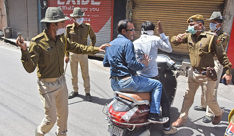 BHILWARA, RAJASTHAN, INDIA - 2020/03/22: Policeman taking action against man during curfew imposed by the authorities in order to control the spread of the deadly coronavirus 'COVID-19' in Bhilwara. The deadly novel coronavirus cases in India rose to 396 on Sunday. (Photo by Sumit Saraswat/Pacific Press/LightRocket via Getty Images)