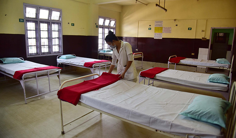 All prepped up; A nurse arranges beds in an isolation ward at a municipal hospital in Nagaon district, Assam | Getty Images
