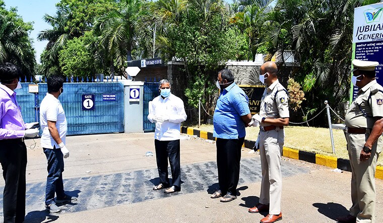 MLA Harsha Vardhan (man in blue shirt) with district in charge minister V Somanna and government officials. pharmaceutical factory in Nanjangud. Photo arranged