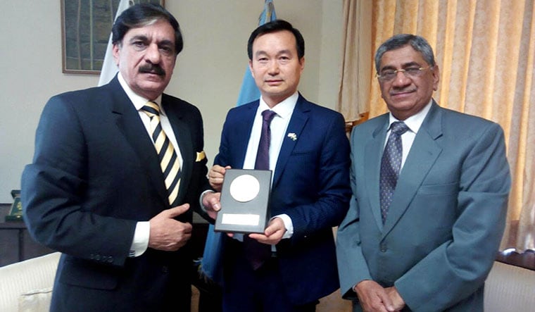 Neighbours in arms: Pakistan’s former national security adviser Lt-Gen Nasser Khan Janjua presenting a shield to Xu Wenhong.