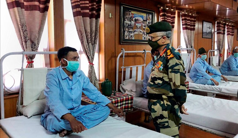 Comfort call: Army chief M.M. Naravane interacts with an injured soldier at the Military Hospital in Leh | PTI