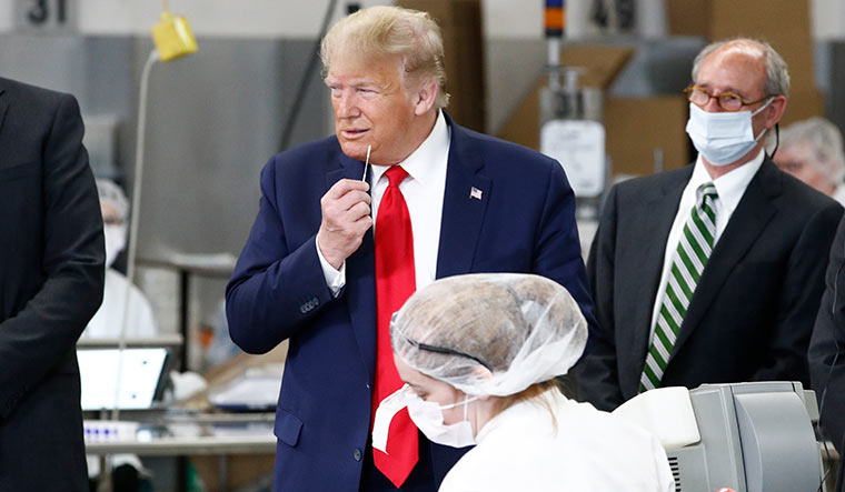 Throwing caution to the wind: President Trump takes a tour of a medical swab manufacturing unit | AP