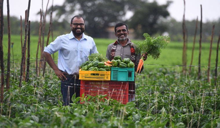 Harvesting happiness: Vasudevan Chinnathambi, cofounder of Ninjacart, with a farmer. Ninjacart used its logistics technology to link farmers to consumers in the locked-down cities | Bhanu Prakash Chandra