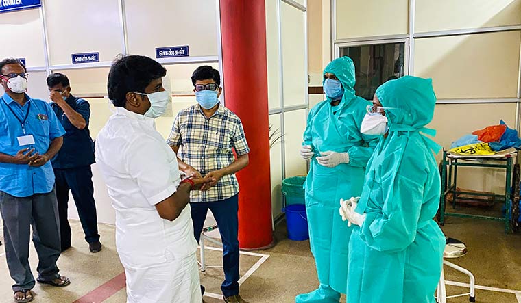 Checking in on heroes: Tamil Nadu Health Minister C. Vijayabaskar interacts with health care workers.