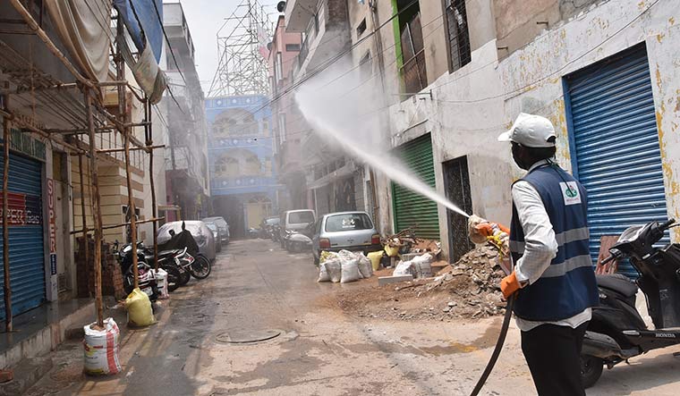 Cleanliness drive: A health worker sprays disinfectant in a containment zone in Hyderabad.