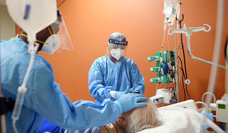 Touch of care: Leesa Surendran attends to a patient in the ICU at Manipal Hospitals in Hebbal, north Bengaluru.
