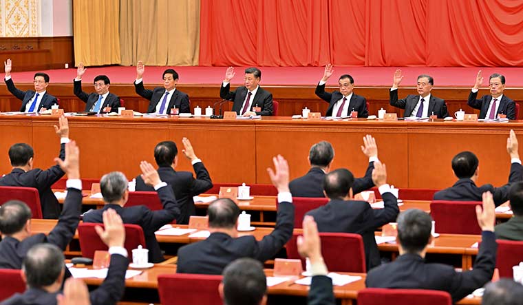 Hail to the chief: The CPC’s seven-member politburo standing committee leads a voting session at the sixth plenum of the central committee on November 11. Xi pushed through a crucial resolution on party history at the plenum, tightening his grip on power | AP