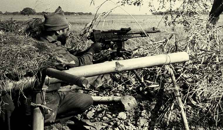 [File] An Indian machine gunner fires at Pakistani positions in a village inside the East Pakistan border during the 1971 war | AP