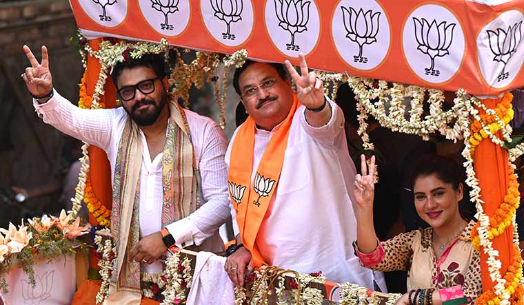 Saffron surge: (From left) Union Minister Babul Supriyo, BJP president J.P. Nadda and actor Payal Sarkar, who is a candidate in Kolkata, during a roadshow in the city | Salil Bera
