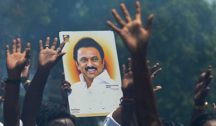 At long last: DMK workers with a placard of Stalin | AFP
