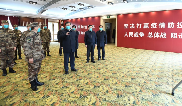 Taking stock: Military personnel brief Chinese President Xi Jinping at a Covid-19 facility in Wuhan in early 2020 | AP