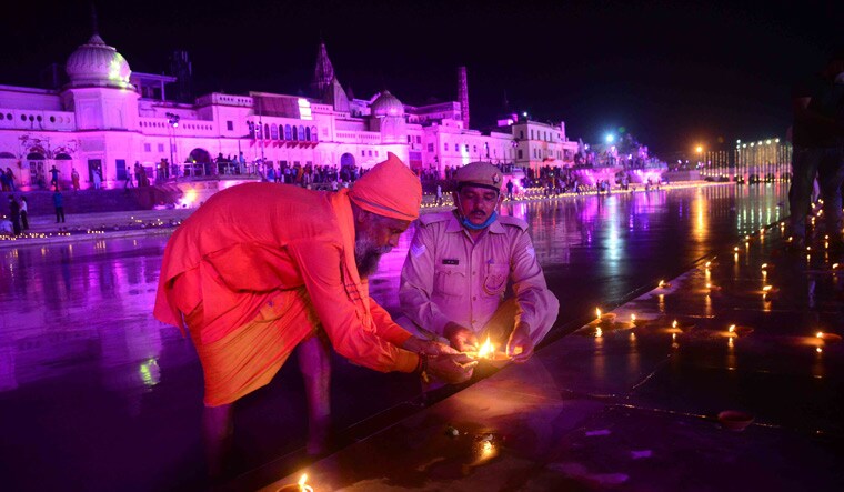 Centre of attention: Two devotees light lamps on the eve of the foundation-laying ceremony of the Ram temple in Ayodhya. The city has sharply influenced the political history of the country | Getty Images