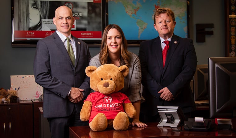 Committed to care: (From right) Pounder; Carly Yoost, CEO and founder of Child Rescue Coalition; Bill Wiltse, president 