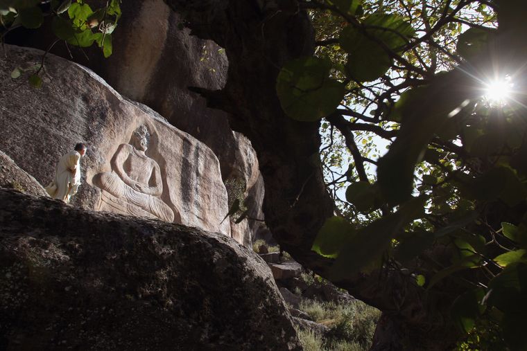 Enduring grace: An ancient Buddha carved on a mountainside at Jehanabad in the Swat Valley of Pakistan. In 2007, Islamic extremists attacked the historic relic in an attempt to destroy it | Getty Images