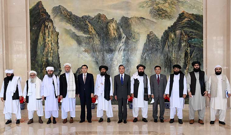 Blooming ties: The Taliban delegation, led by Mullah Abdul Ghani Baradar (sixth from left) after meeting China’s Foreign Minister Wang Yi (to Baradar’s left) and other officials in Tianjin, China, in July | Twitter/ MFA_China