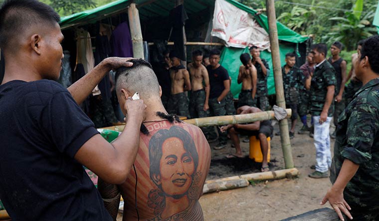 Fighting back: A member of the People’s Defence Force gets a military-style haircut at a training camp in an area controlled by ethnic Karen rebels in  Myanmar | Reuters