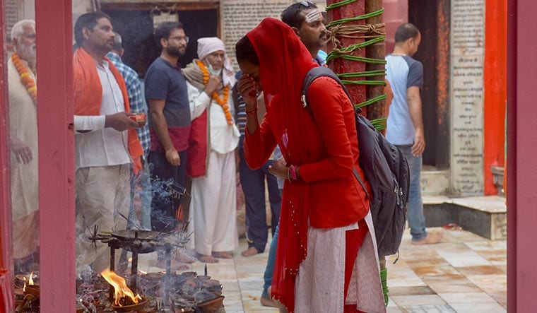 Faith matters: A devotee offers prayers in Ayodhya. The BJP banks on hindutva and welfarism to win the polls | Salil Bera