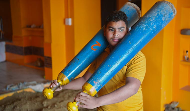 Om Harinarayan Chaudhary, the 16-year-old who is referred to as Dom Raja, the king of cremations.