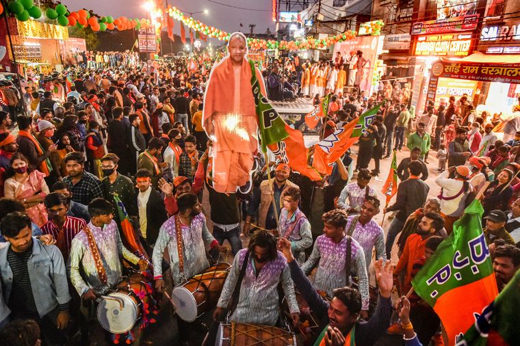 Larger than life: BJP supporters at a roadshow of Chief Minister Yogi Adityanath  in Lucknow | PTI