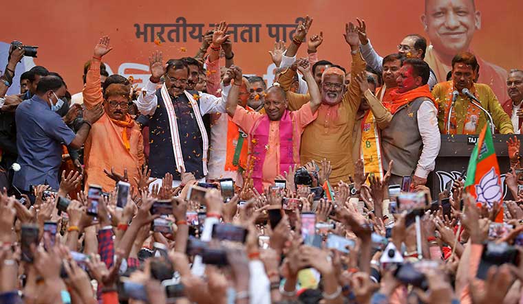 Thumping victory: Yogi Adityanath celebrates with party members and supporters at the BJP office in Lucknow | Reuters