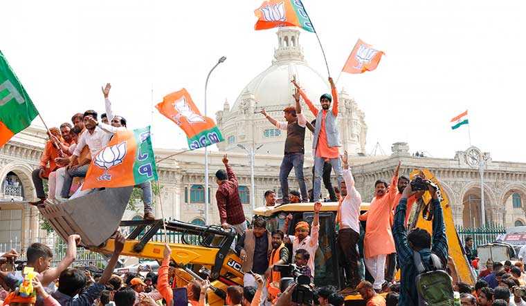 Unstoppable: BJP supporters celebrating victory on an excavator in Lucknow | Pawan Kumar
