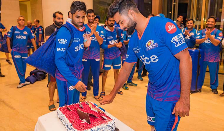 Sweet gesture: Kartikeya cuts the cake as the team celebrates one of the wins in the IPL | Courtesy Mumbai Indians