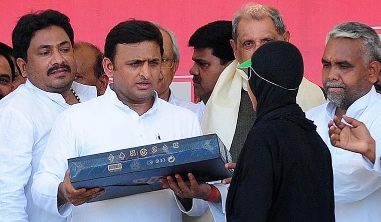 New lessons: A student receives a laptop from Uttar Pradesh chief minister Akhilesh Yadav in 2013 | AFP