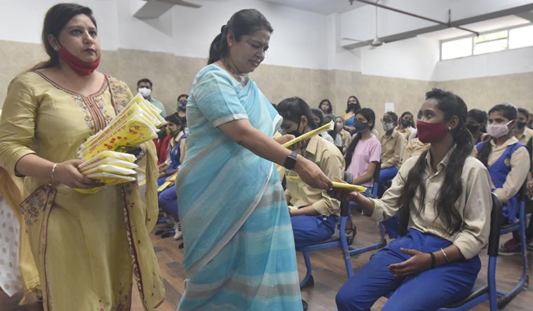Basic needs: Union minister Meenakshi Lekhi distributes sanitary pads after inaugurating the automatic sanitary pad manufacturing machines at the Women's Technical Institute in Delhi | Getty Images