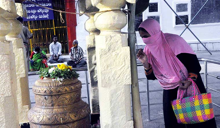 Prayer for all: A Muslim devotee at the Sri Lakshmi Venkateshwara Swamy temple.