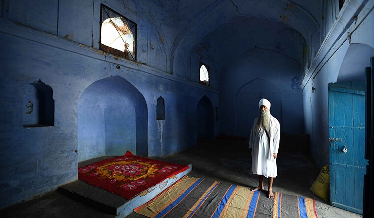 The multitasker: Jeet Singh, the custodian of the Guru Granth Sahib of Mastgarh Sahib Chittian Gurdwara, is also the caretaker of Chittian Masjid, located next to the gurdwara | Sanjay Ahlawat