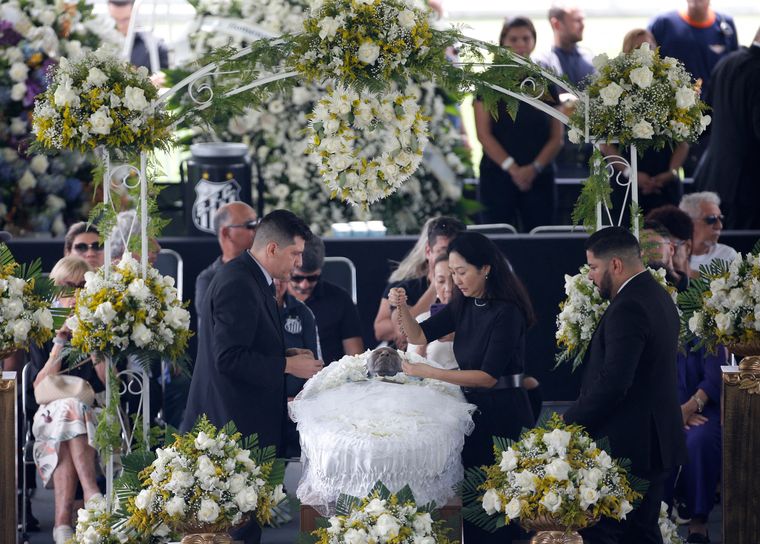 Final goodbye: Pele lies in state at the Vila Belmiro stadium in Santos, São Paulo. His widow Marcia Cibele Aoki stands over the casket. Pele died on december 29 after a prolonged battle with colon cancer | Reuters
