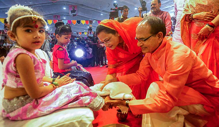 Emotional connect: Madhya Pradesh Chief Minister Shivraj Singh Chouhan with wife, Sadhna Singh, during ‘Kanya Puja’ on the Navratri festival in Bhopal | PTI