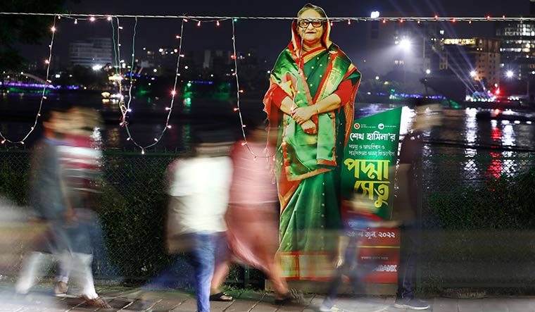 Standing tall: S cutout of Prime Minister Sheikh Hasina on a street in Dhaka before the inauguration of the Padma bridge | Getty Images