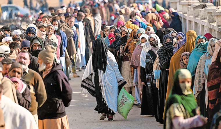 Struggle for existence: Local residents queue up to buy wheat flour at government-controlled prices in Islamabad | AFP
