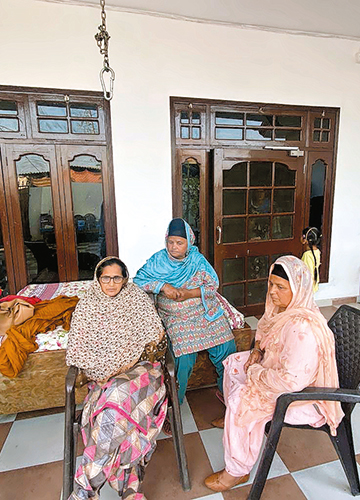 On edge: Amritpal's mother, Balwinder Kaur (extreme left), with neighbours Parvinder Kaur and Rajwant Kaur | Namrata Biji Ahuja