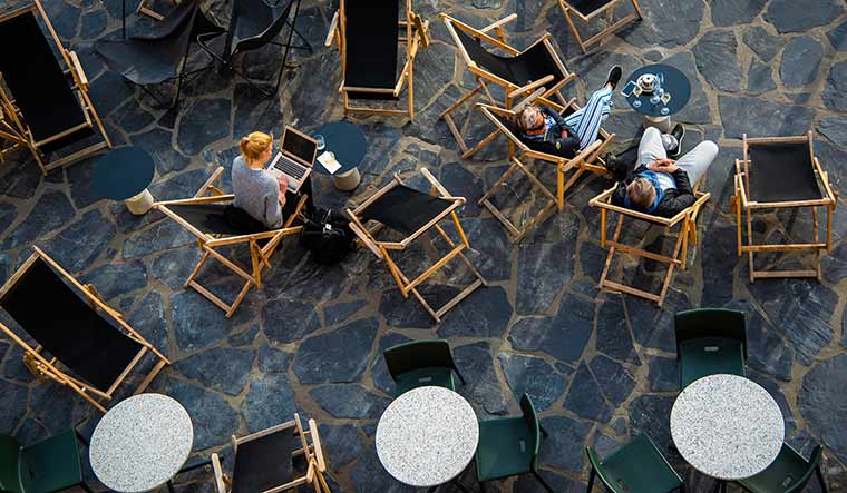 Rest, refresh: People enjoy drinks on the terrace of a cafe in Helsinki. Studies show “downtime” is not time wasted | Shutterstock