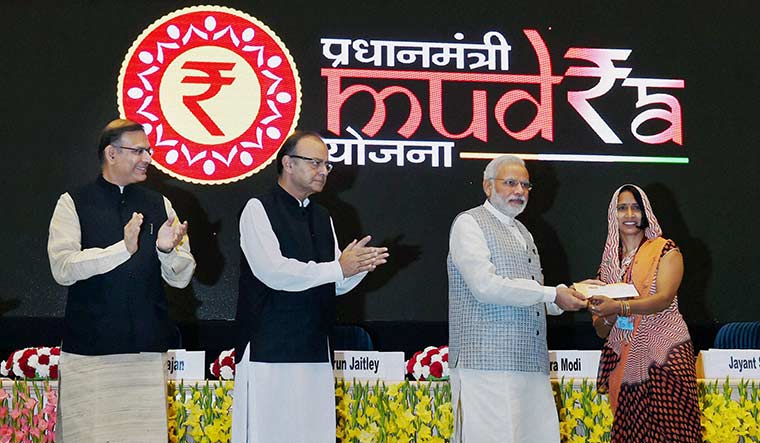 Lending a helping hand: A 2015 photo of Prime Minister Modi handing over a cheque at the launch of the MUDRA scheme | PTI