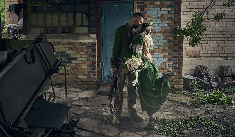 Kiss over kill: Volunteer military medics, code named Nikita and Polka, during their wedding at their position on the frontline in the Donetsk region in Ukraine | AP