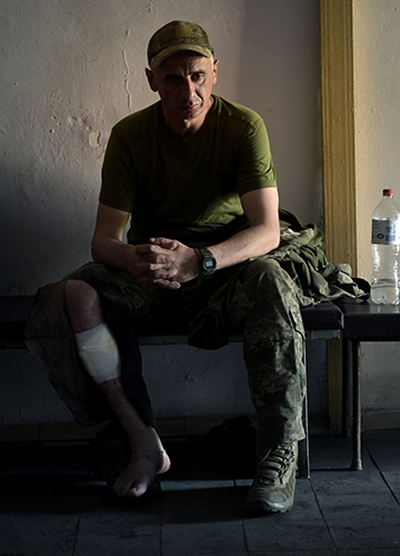 Raring to go back and fight: An injured soldier rests in a stabilisation centre at Lyman after being attended to by first responders.