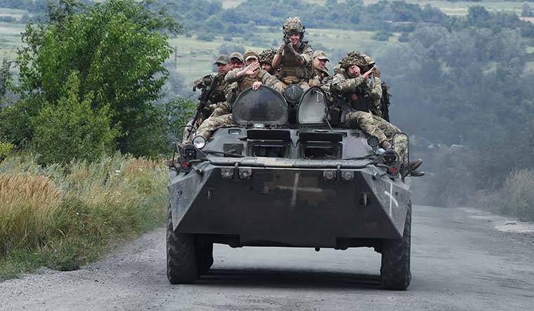 59-Infantrymen-riding-an-armoured-personnel-carrier-near