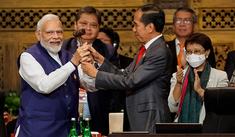 Assuming charge: Prime Minister Narendra Modi taking over the presidency of the G20 from Indonesia’s President Joko Widodo at Bali in November 2022 | AFP