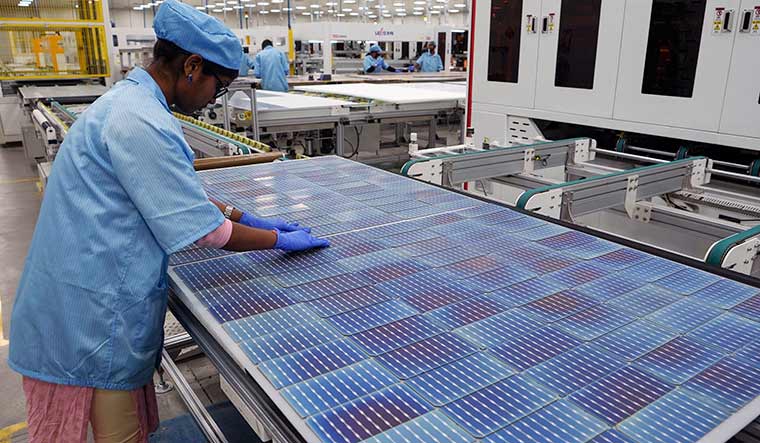 Power pack: A worker arranges solar cells at Premier Energies on the outskirts of Hyderabad | AP