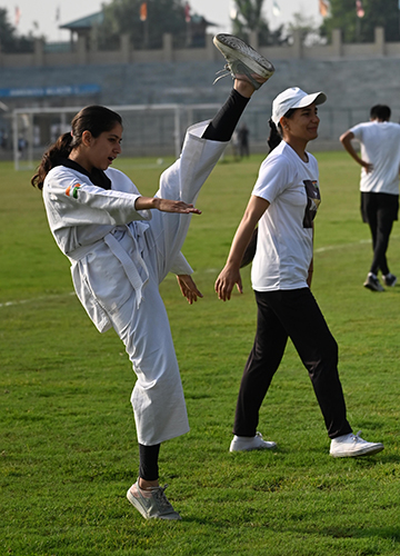 Higher and stronger: A girl practising taekwondo at Bakshi Stadium in Srinagar